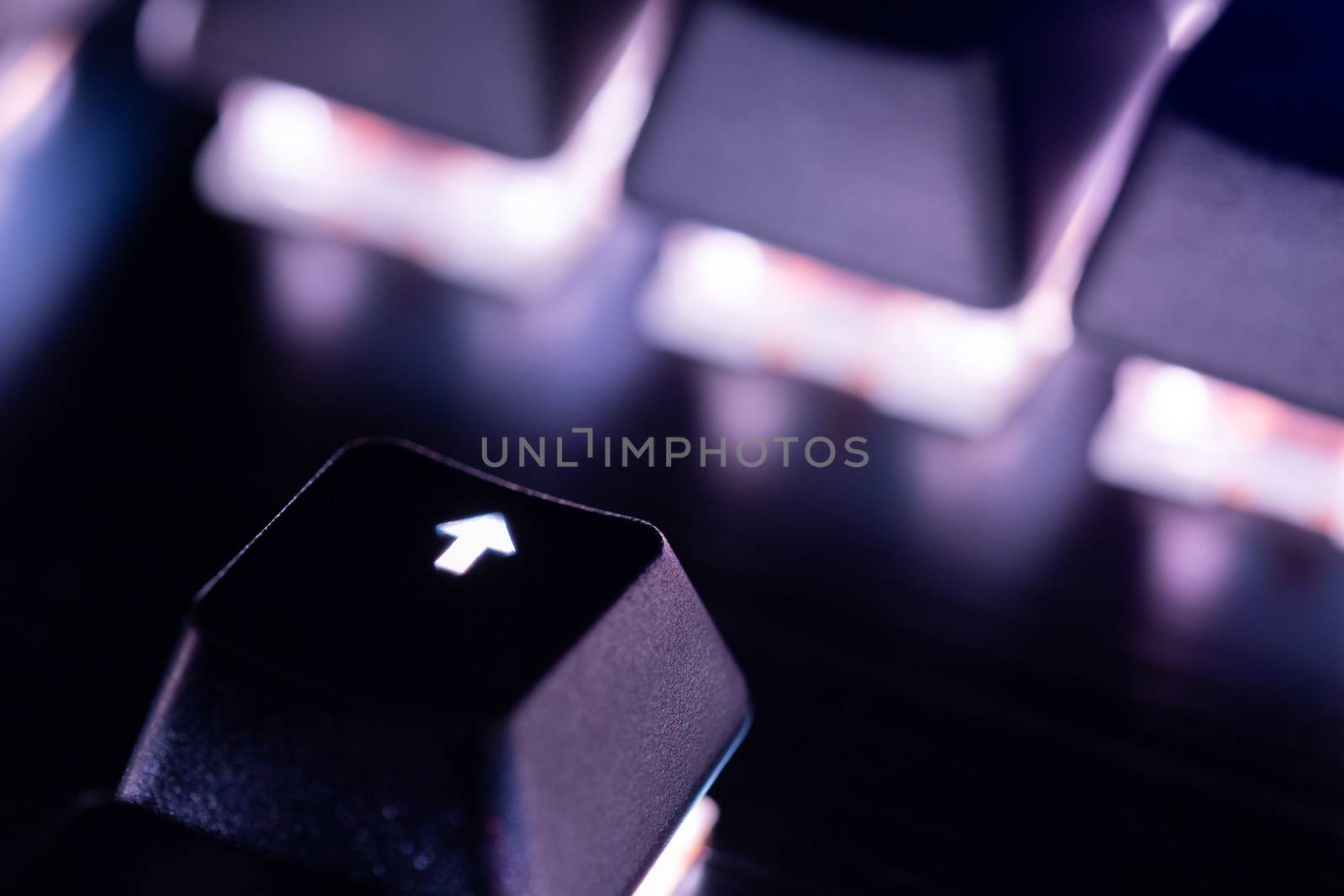 a close-up view of black mechanical pc keyboard with white backlight.