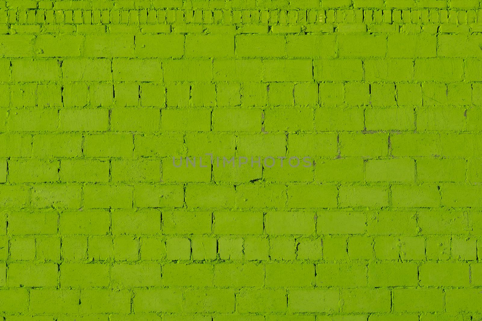 green plaster rough brick wall texture under direct sunlight