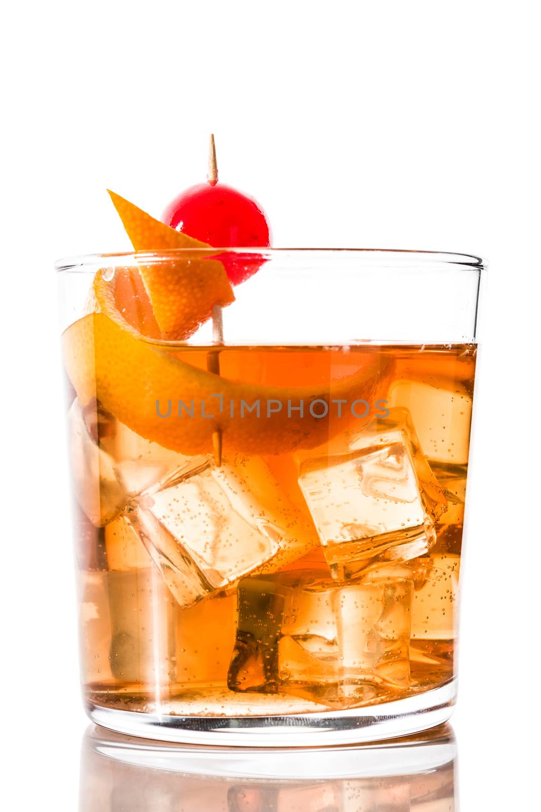 Old fashioned cocktail with orange and cherry isolated on white background