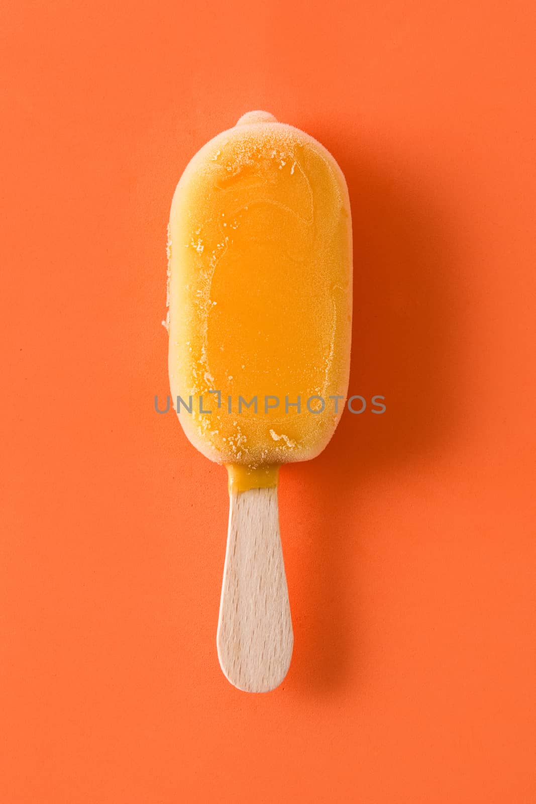 Orange popsicles on orange background