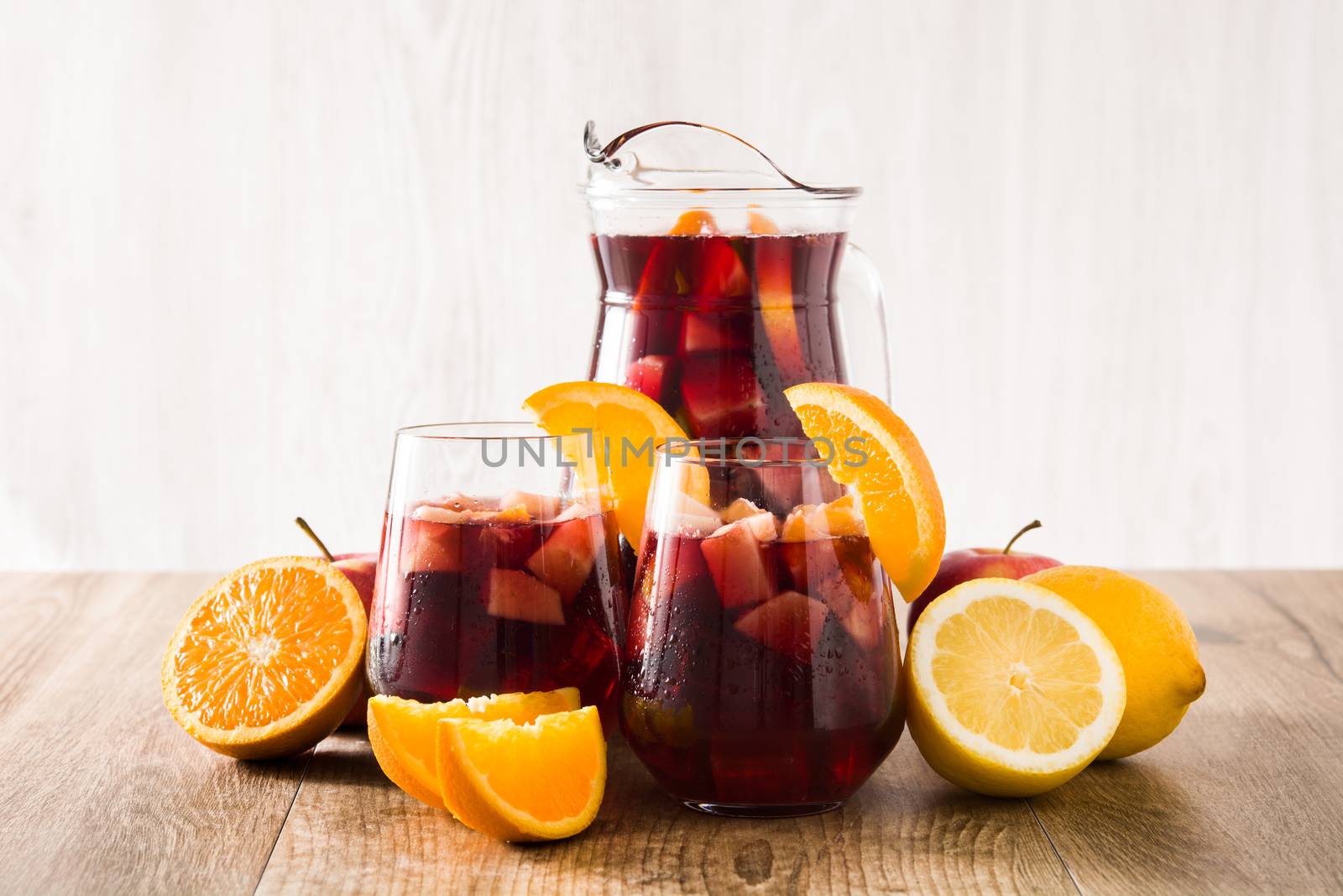Red wine sangria in glass on wooden table. by chandlervid85