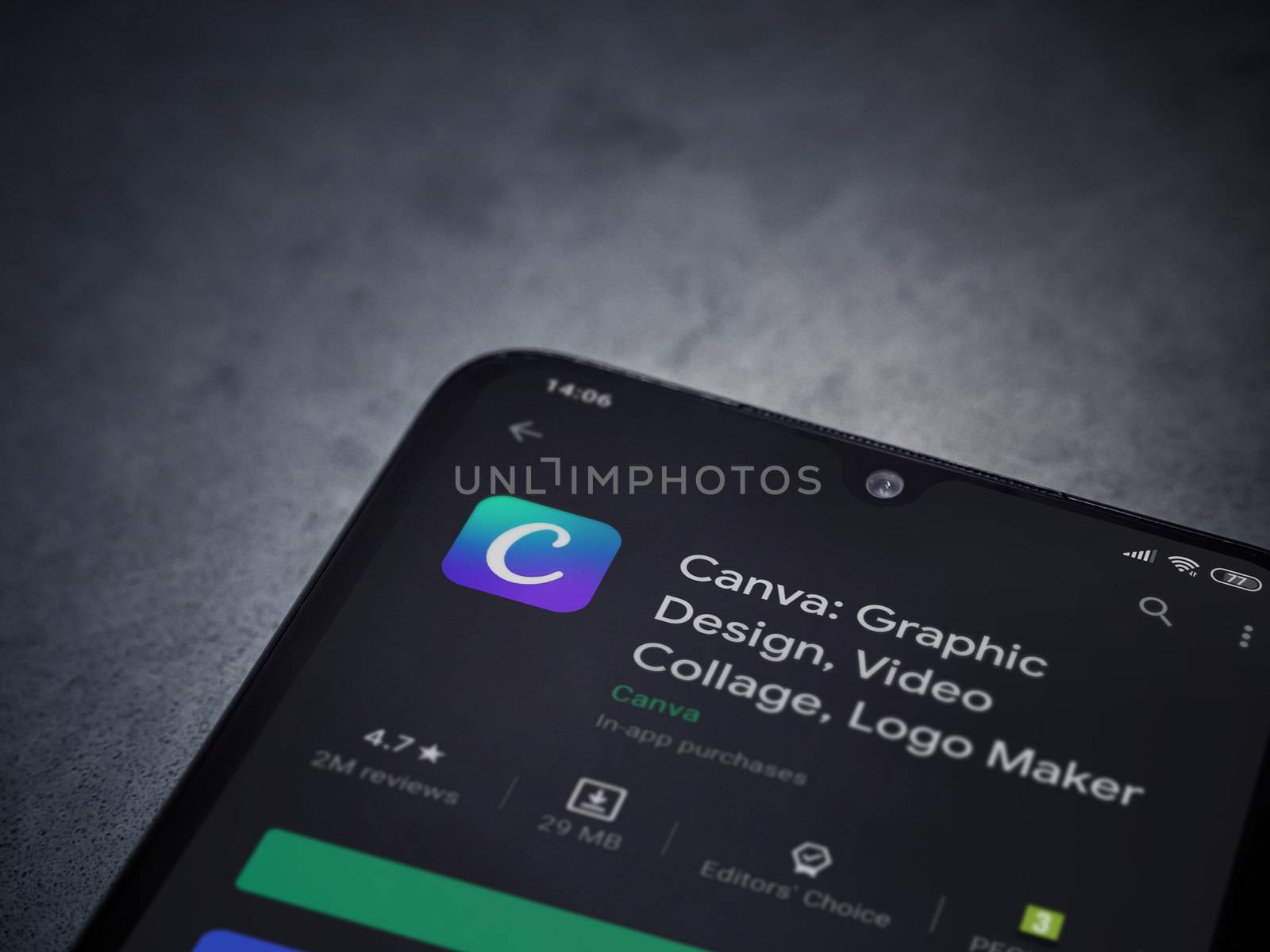 Lod, Israel - July 8, 2020: Canva - Graphic Design app play store page on the display of a black mobile smartphone on a dark marble stone background. Top view flat lay with copy space. 