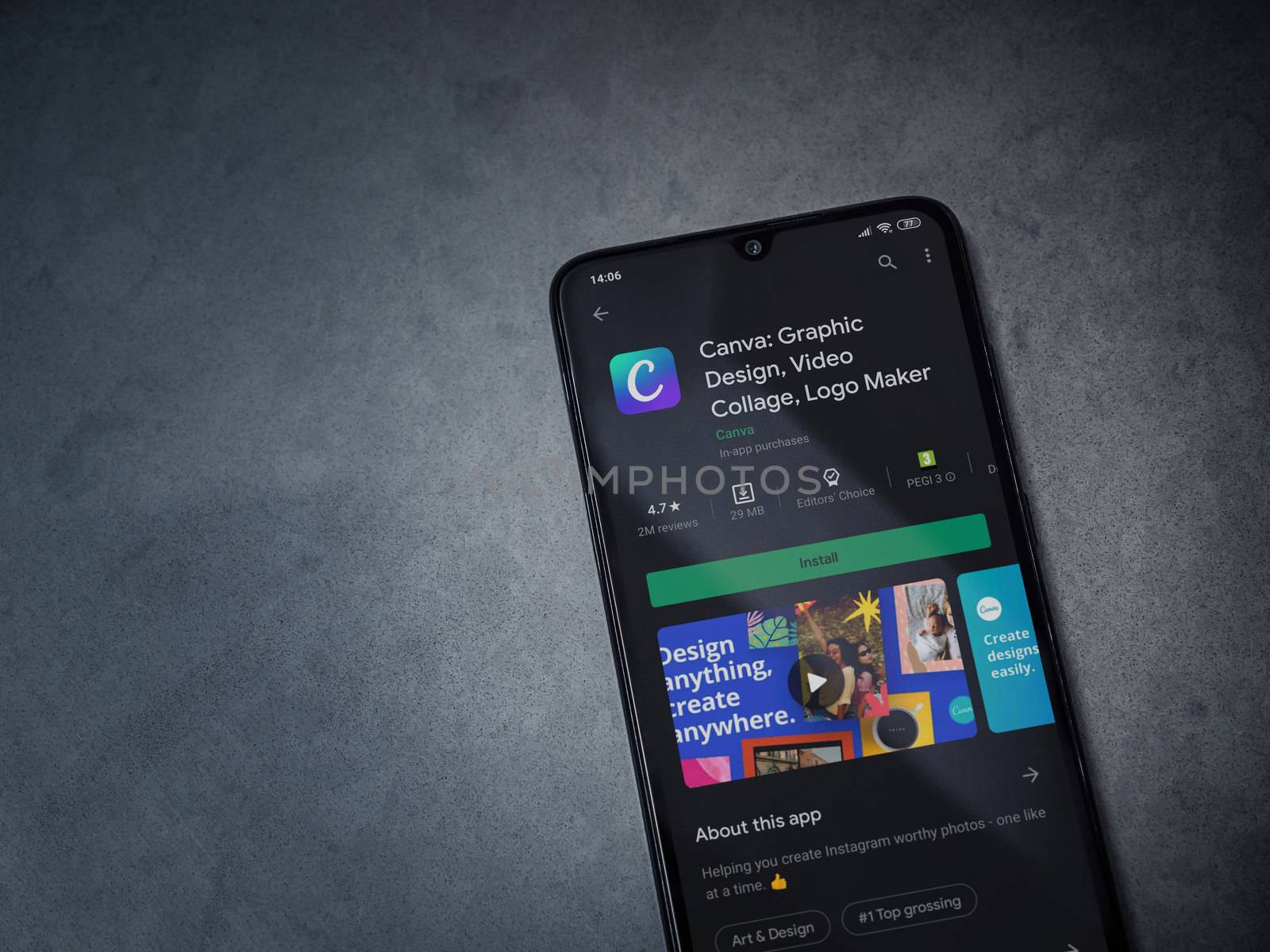 Lod, Israel - July 8, 2020: Canva - Graphic Design app play store page on the display of a black mobile smartphone on a dark marble stone background. Top view flat lay with copy space. 