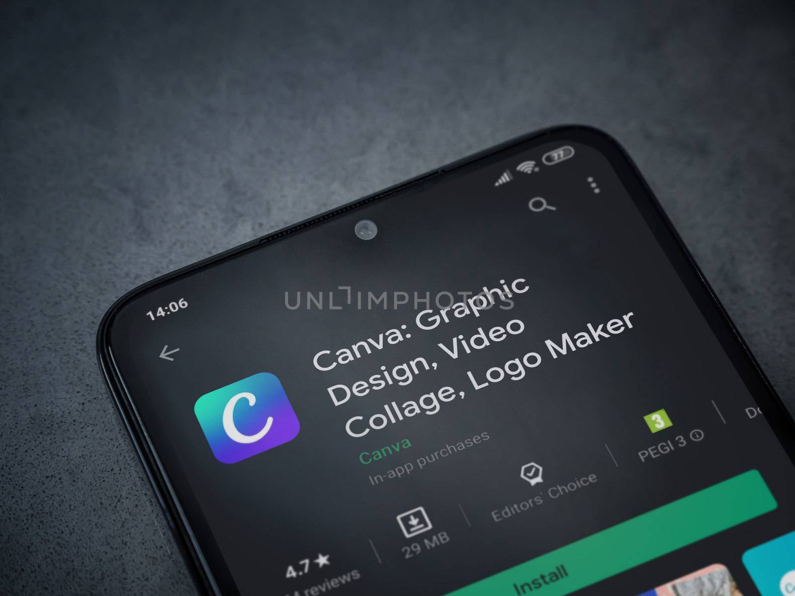 Lod, Israel - July 8, 2020: Canva - Graphic Design app play store page on the display of a black mobile smartphone on a dark marble stone background. Top view flat lay with copy space. 