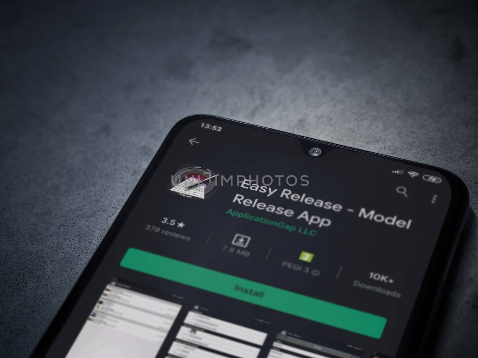 Lod, Israel - July 8, 2020: Easy Release Pro - Model Release app play store page on the display of a black mobile smartphone on a dark marble stone background. Top view flat lay with copy space. 