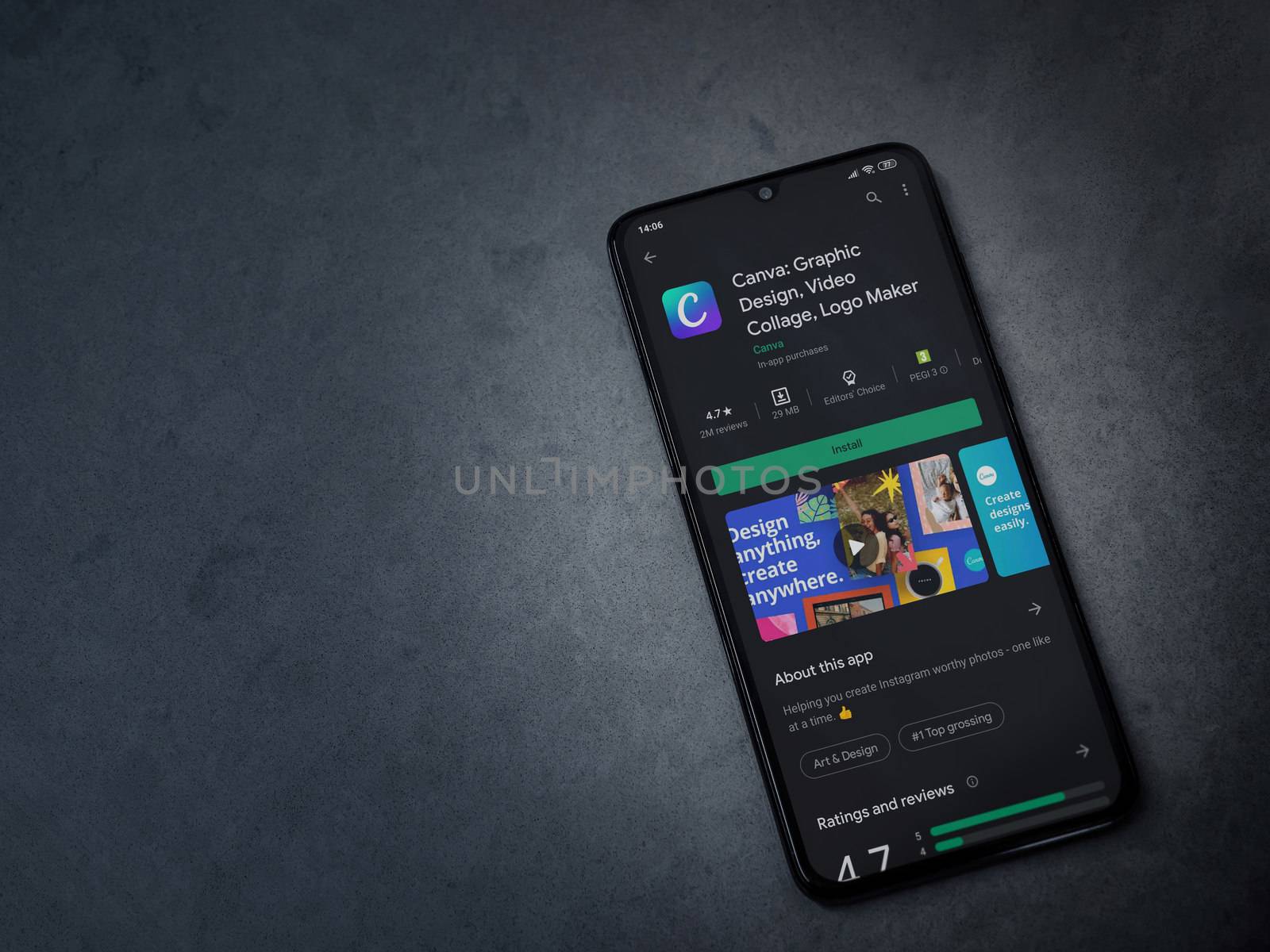 Lod, Israel - July 8, 2020: Canva - Graphic Design app play store page on the display of a black mobile smartphone on a dark marble stone background. Top view flat lay with copy space. 
