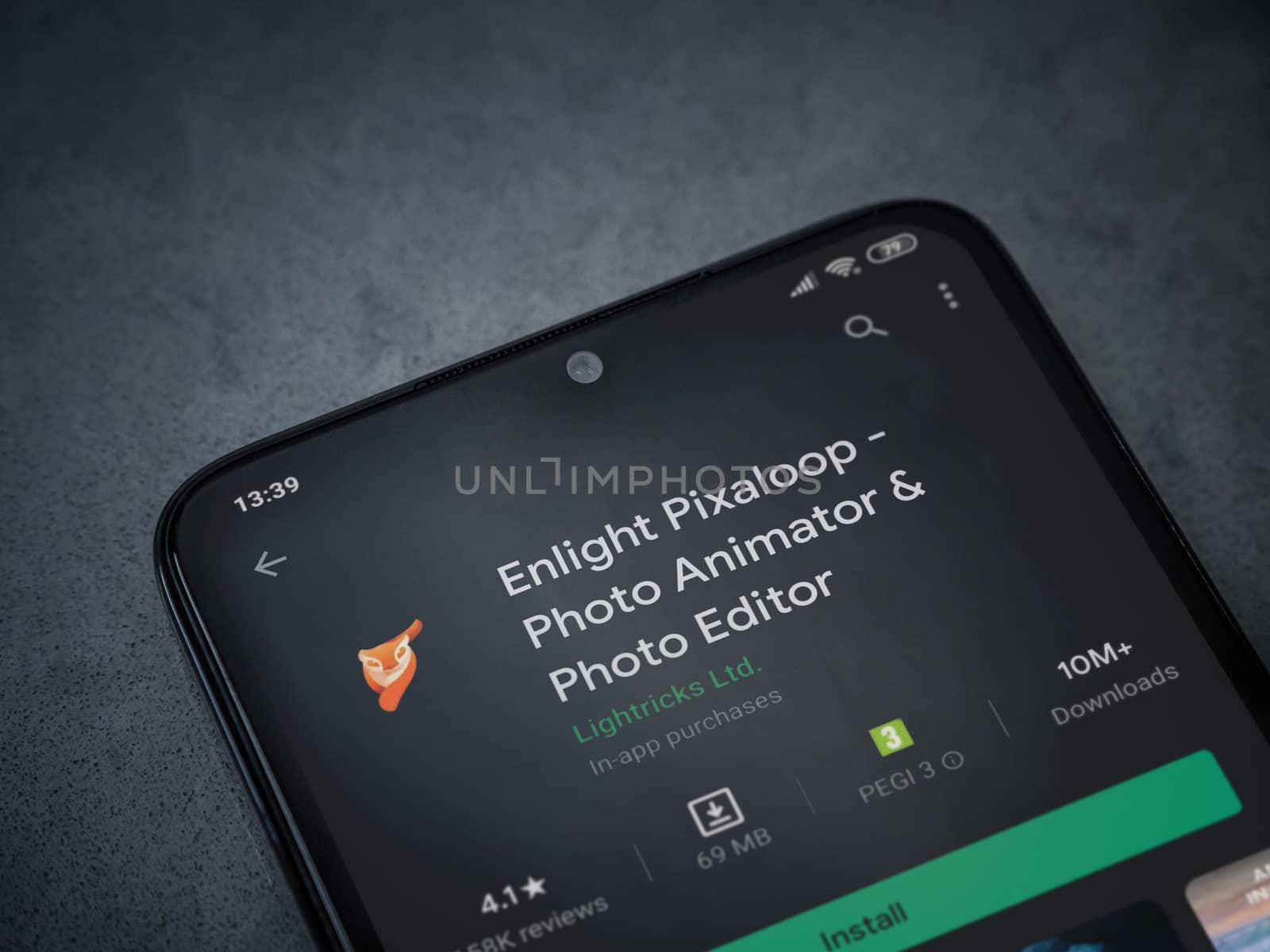 Lod, Israel - July 8, 2020: Enlight Pixaloop app play store page on the display of a black mobile smartphone on a dark marble stone background. Top view flat lay with copy space.