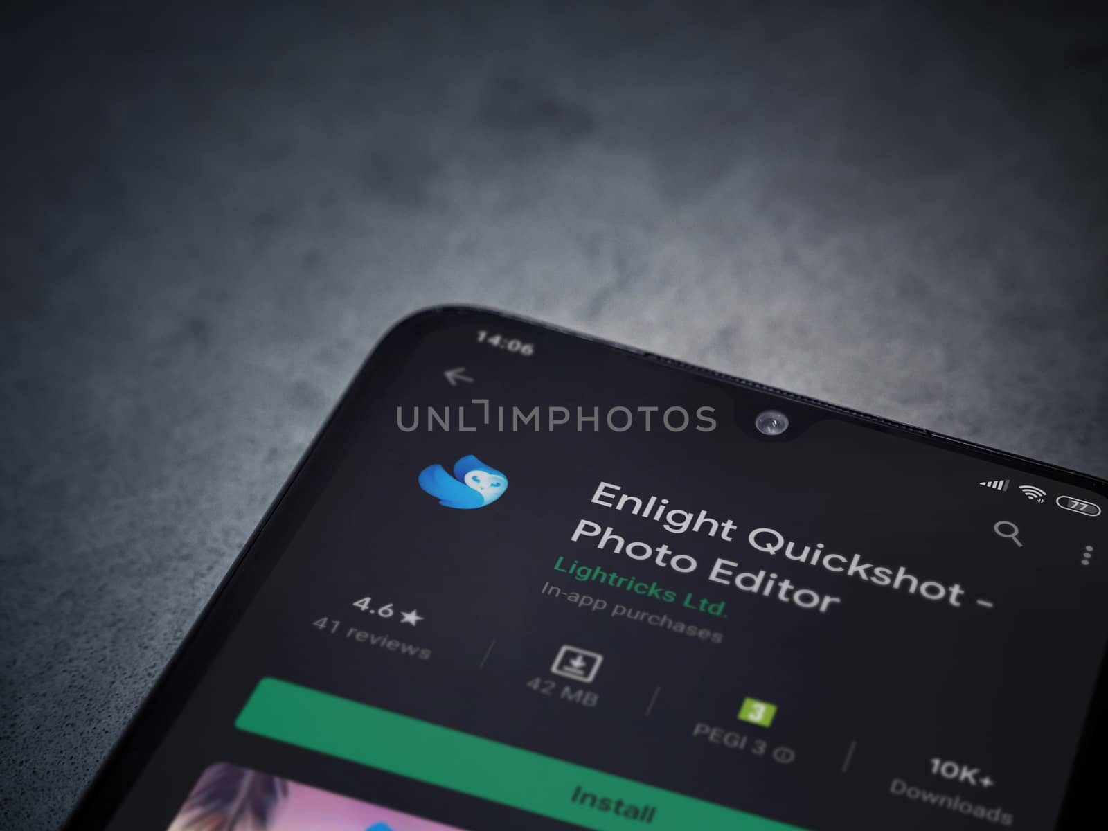 Lod, Israel - July 8, 2020: Enlight Quickshot app play store page on the display of a black mobile smartphone on a dark marble stone background. Top view flat lay with copy space.
