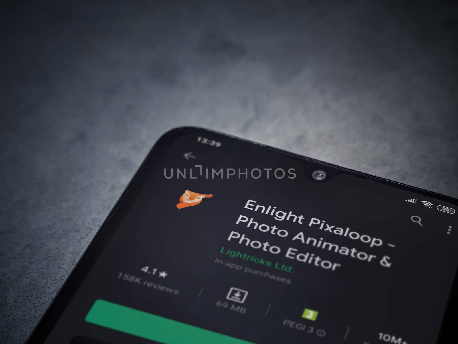 Lod, Israel - July 8, 2020: Enlight Pixaloop app play store page on the display of a black mobile smartphone on a dark marble stone background. Top view flat lay with copy space.