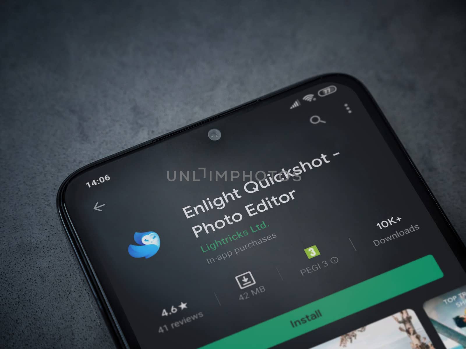 Lod, Israel - July 8, 2020: Enlight Quickshot app play store page on the display of a black mobile smartphone on a dark marble stone background. Top view flat lay with copy space.