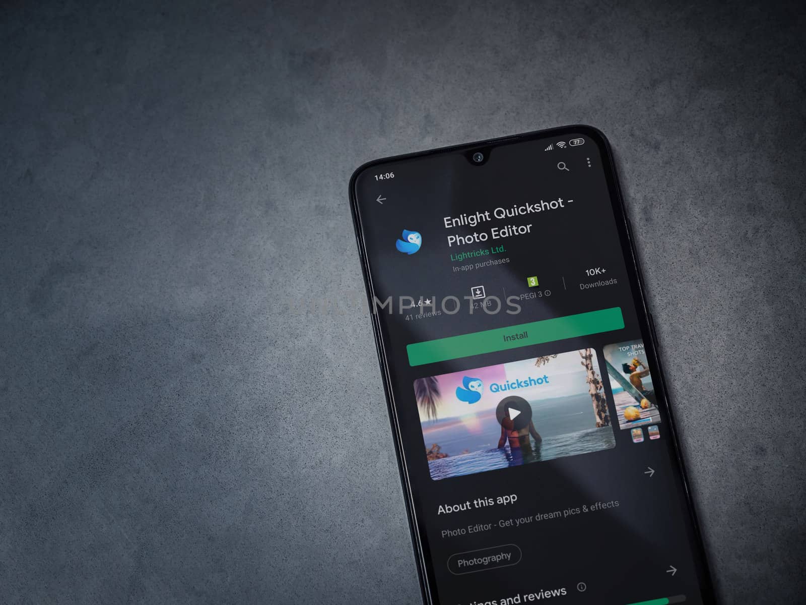 Lod, Israel - July 8, 2020: Enlight Quickshot app play store page on the display of a black mobile smartphone on a dark marble stone background. Top view flat lay with copy space.