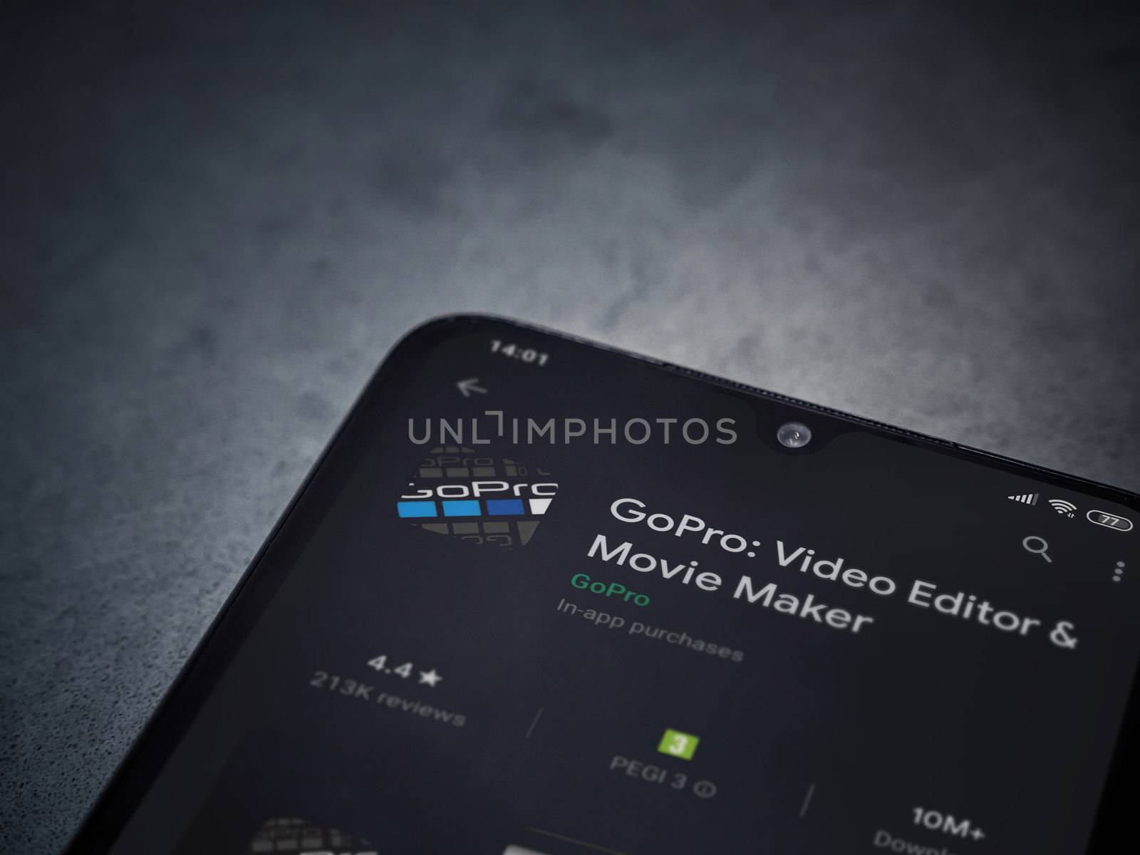 Lod, Israel - July 8, 2020: GoPro - Video Editor and Movie Maker app play store page on the display of a black mobile smartphone on a dark marble stone background. Top view flat lay with copy space.
