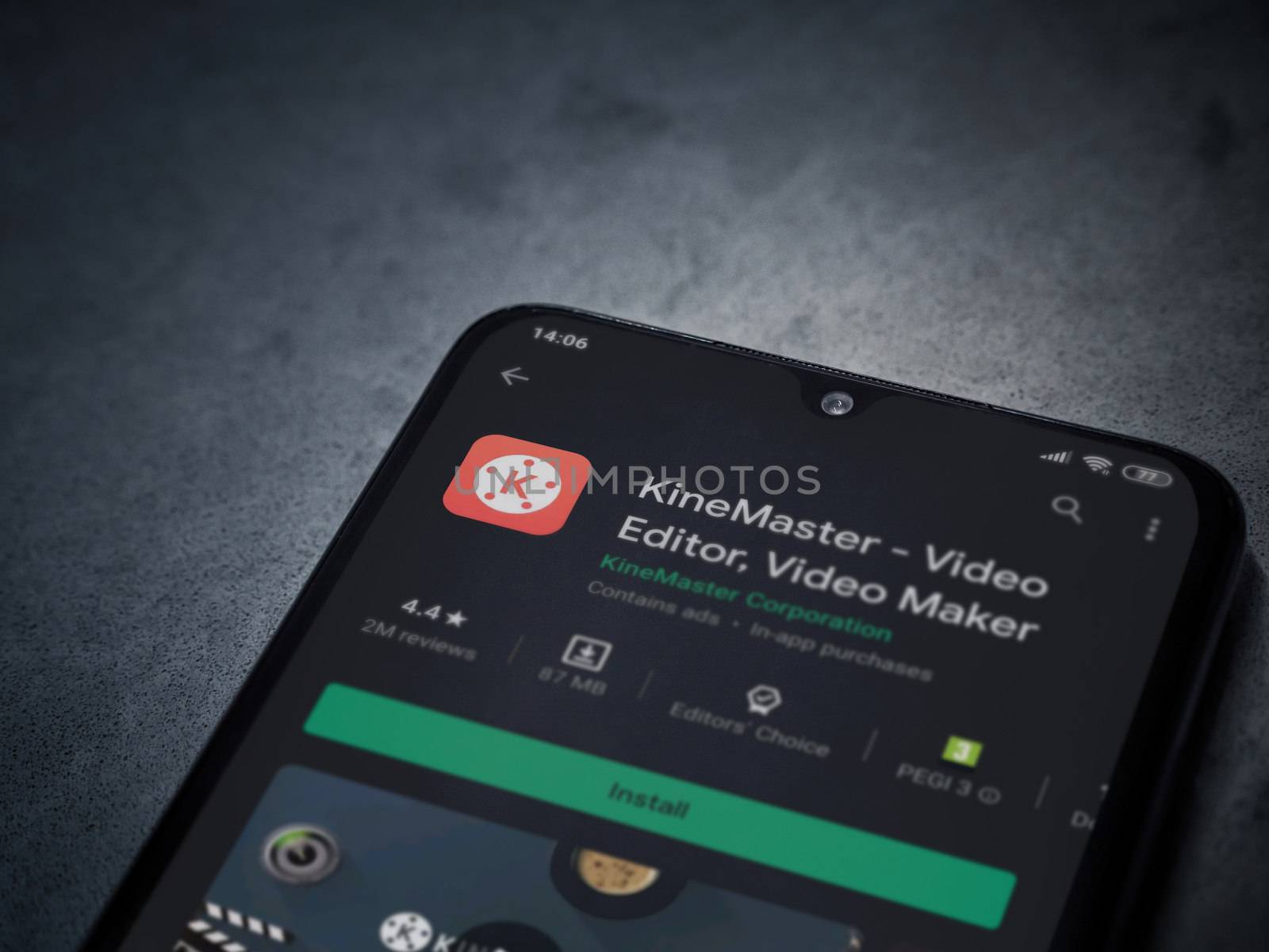 Lod, Israel - July 8, 2020: KineMaster - Video Editor and Movie Maker app play store page on the display of a black mobile smartphone on a dark marble stone background. Top view flat lay with copy space.