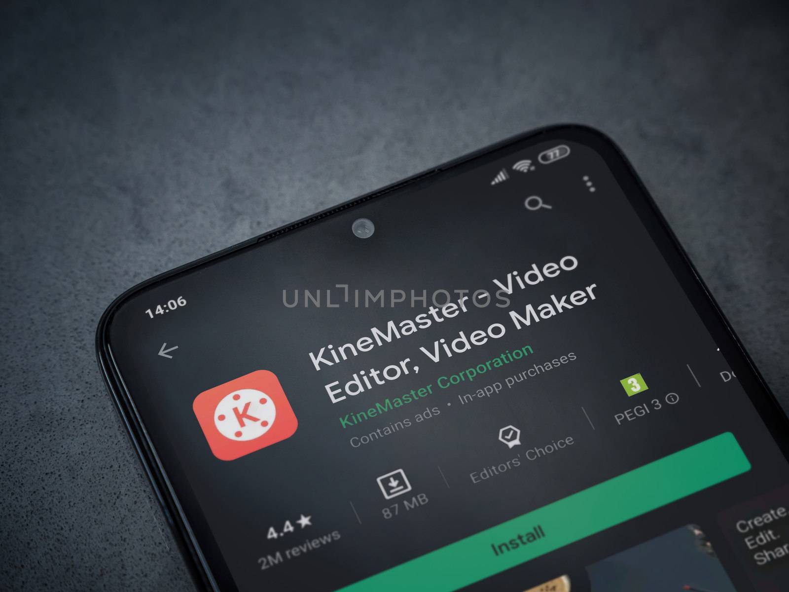 Lod, Israel - July 8, 2020: KineMaster - Video Editor and Movie Maker app play store page on the display of a black mobile smartphone on a dark marble stone background. Top view flat lay with copy space.