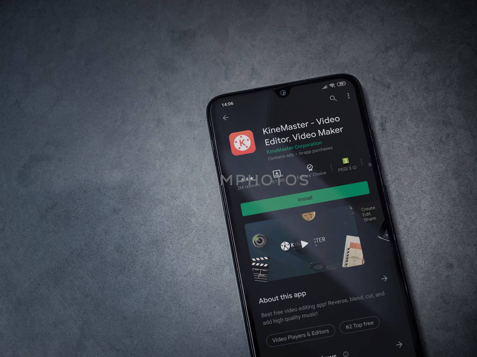 Lod, Israel - July 8, 2020: KineMaster - Video Editor and Movie Maker app play store page on the display of a black mobile smartphone on a dark marble stone background. Top view flat lay with copy space.
