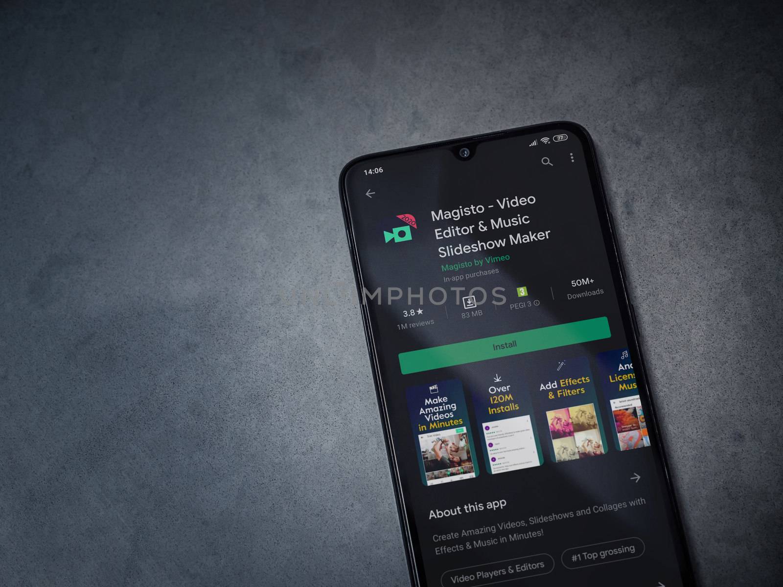 Lod, Israel - July 8, 2020: Magisto - Video Editor and Movie Maker app play store page on the display of a black mobile smartphone on a dark marble stone background. Top view flat lay with copy space.