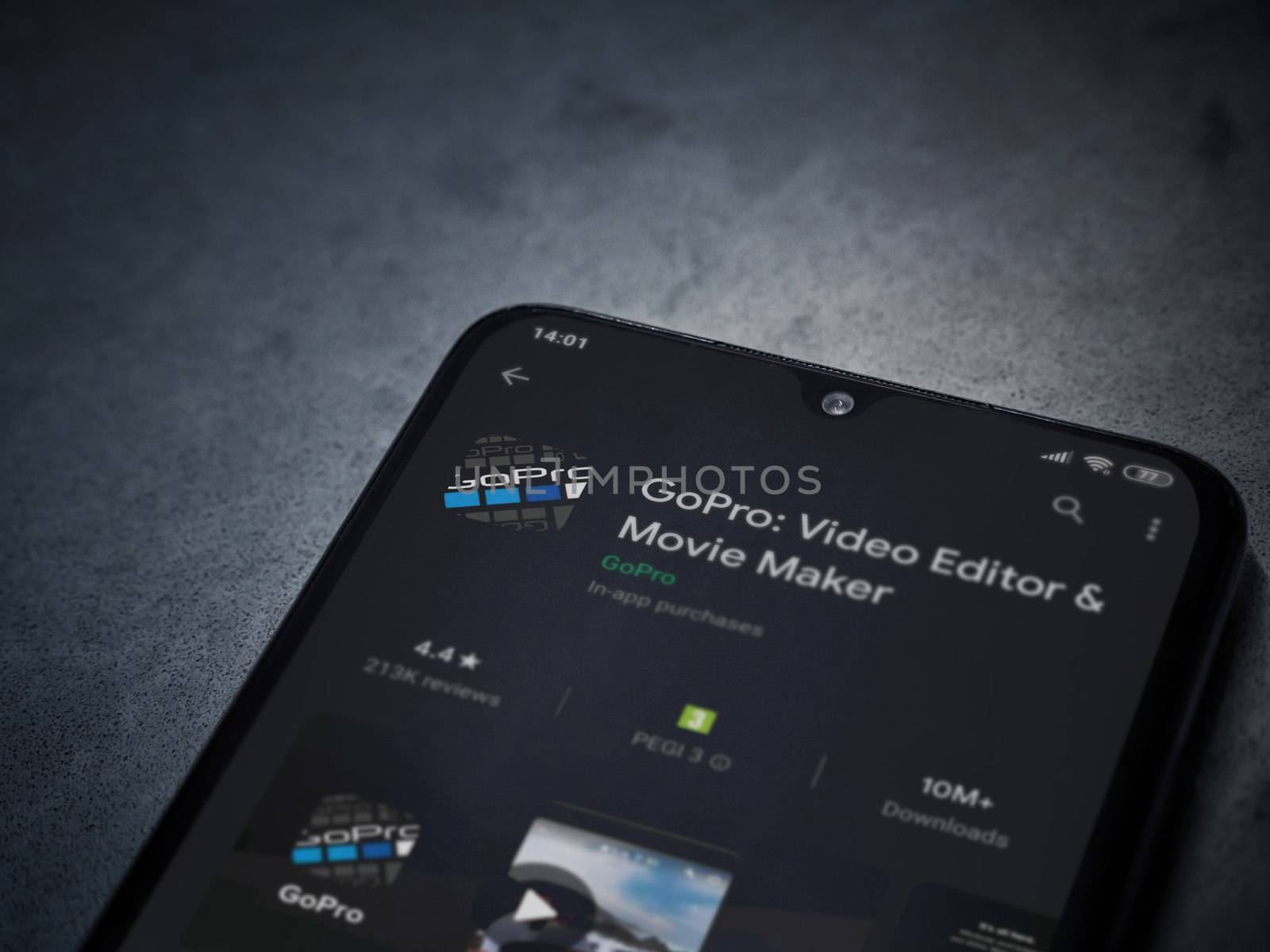Lod, Israel - July 8, 2020: GoPro - Video Editor and Movie Maker app play store page on the display of a black mobile smartphone on a dark marble stone background. Top view flat lay with copy space.