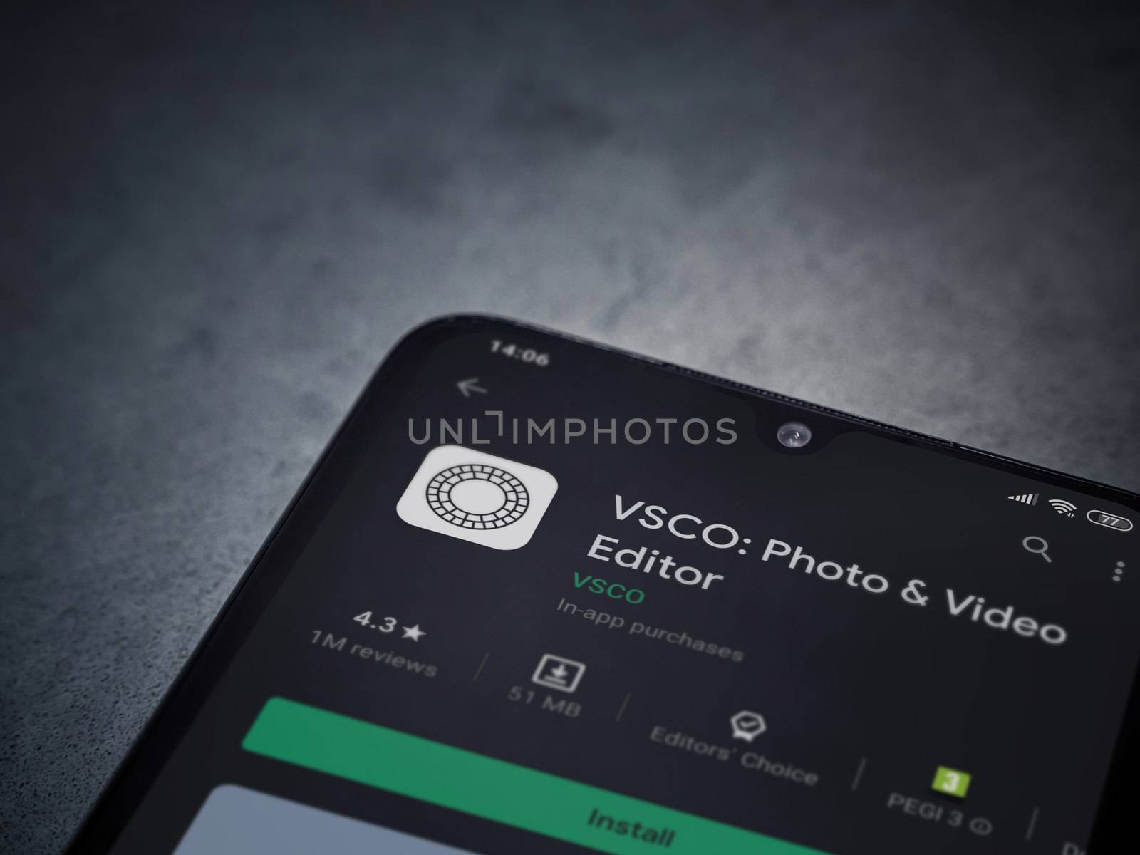 Lod, Israel - July 8, 2020: VSCO - Photo and Video Editor app play store page on the display of a black mobile smartphone on a dark marble stone background. Top view flat lay with copy space. 