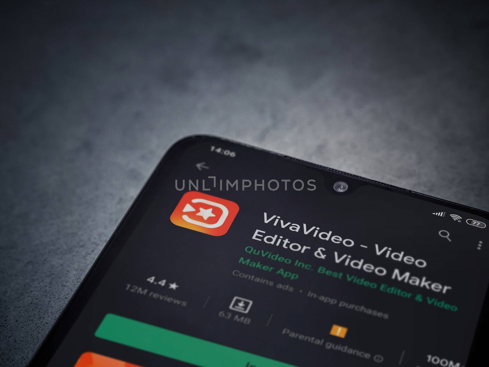Lod, Israel - July 8, 2020: VivaVideo - Video Editor and Movie Maker app play store page on the display of a black mobile smartphone on a dark marble stone background. Top view flat lay with copy space.