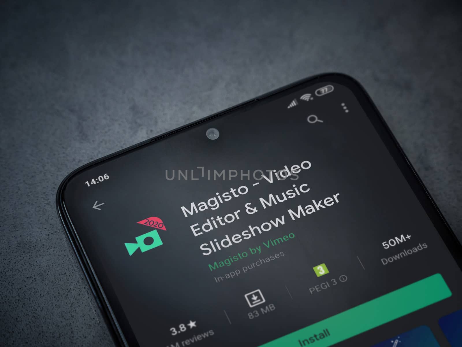 Lod, Israel - July 8, 2020: Magisto - Video Editor and Movie Maker app play store page on the display of a black mobile smartphone on a dark marble stone background. Top view flat lay with copy space.