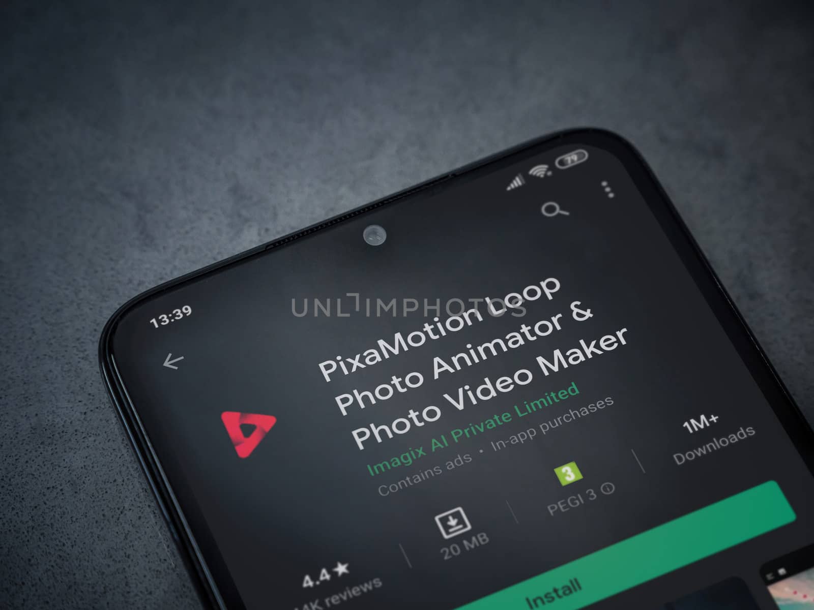 Lod, Israel - July 8, 2020: PixaMotion app play store page on the display of a black mobile smartphone on a dark marble stone background. Top view flat lay with copy space.
