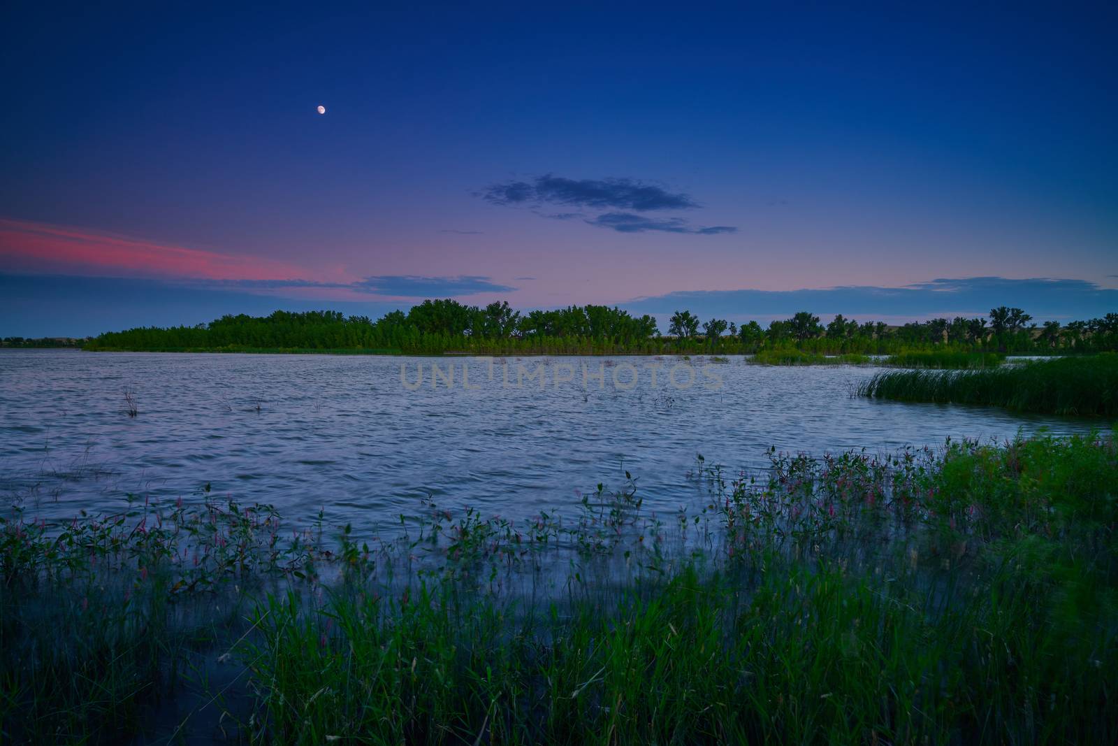 Moonrise over Oliver Reserve in Nebraska. by patrickstock