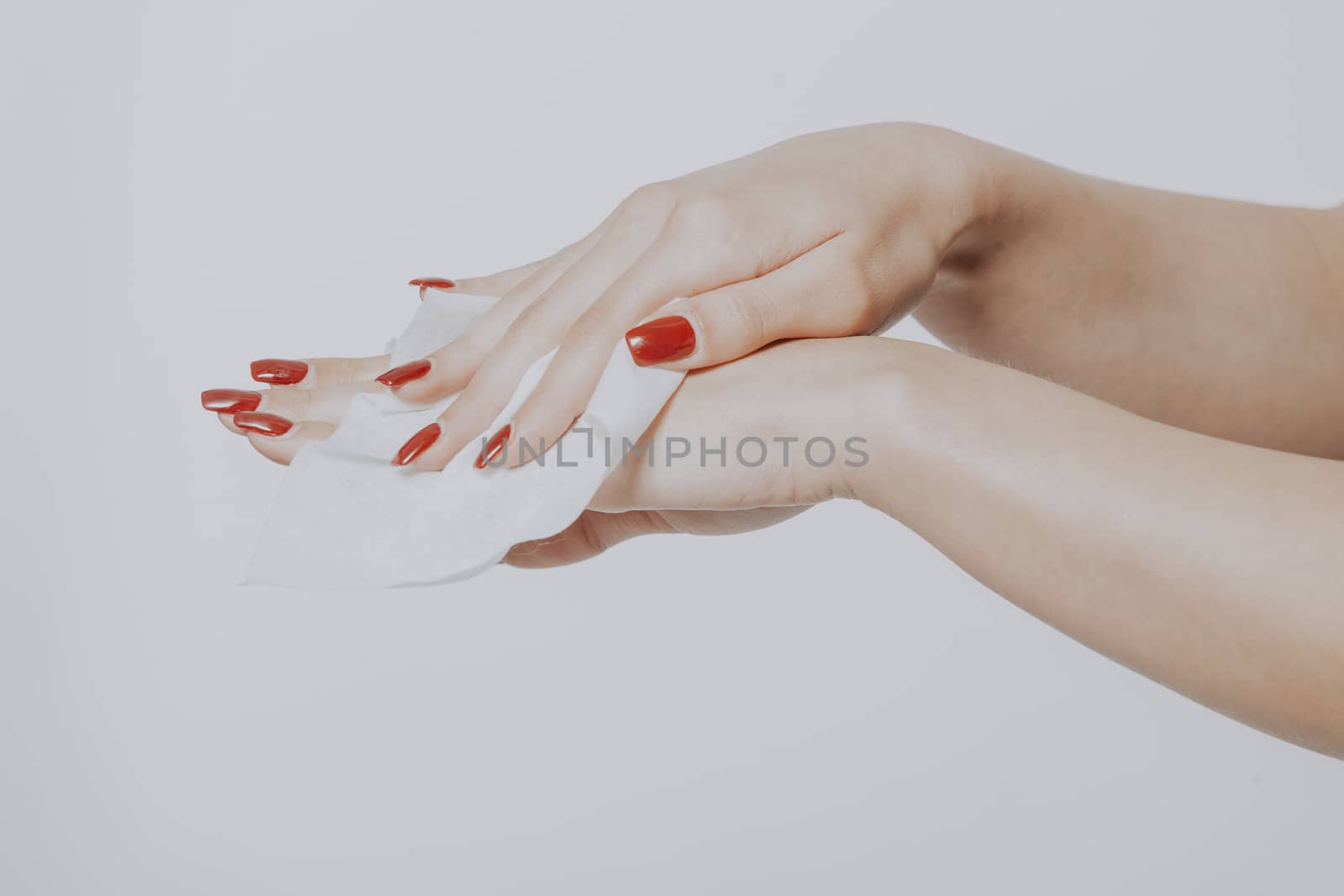 Young woman clean hands with wet wipes