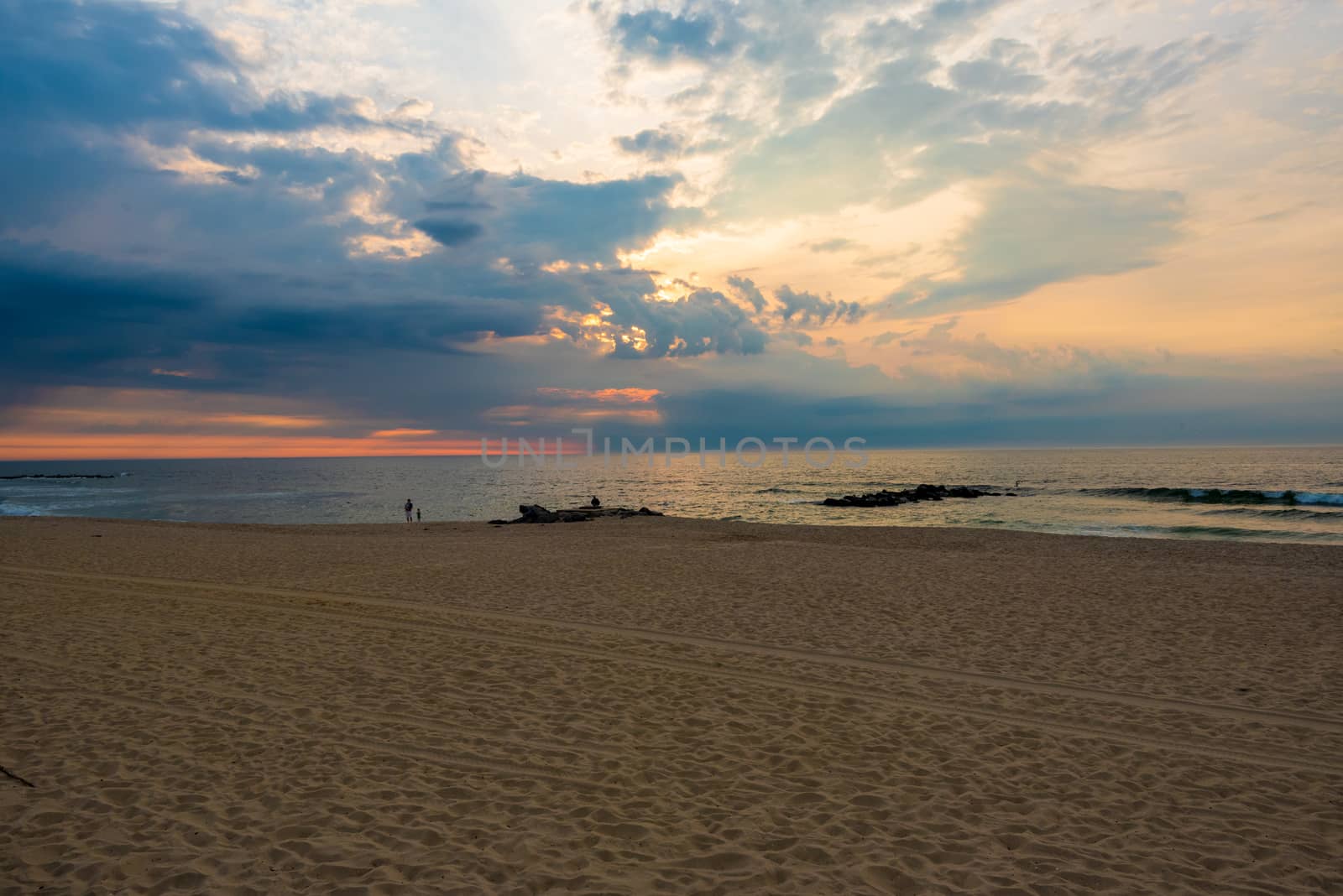 A wide angle photo of a beautiful sunrise over the Atlantic Ocean in Spring Lake, NJ on the 4th of July.