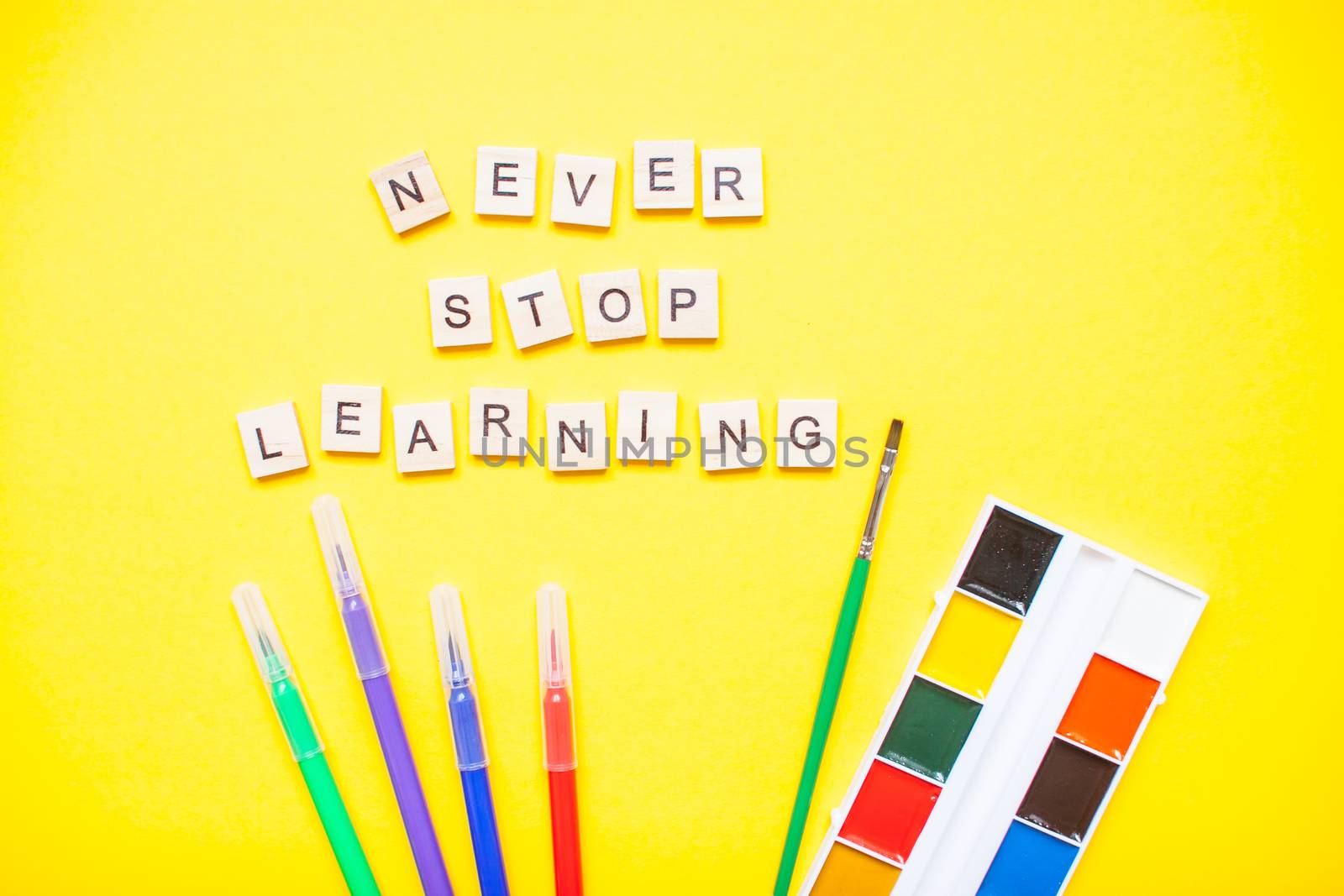 Words from wooden blocks "never stop learning" and stationery by malyshkamju