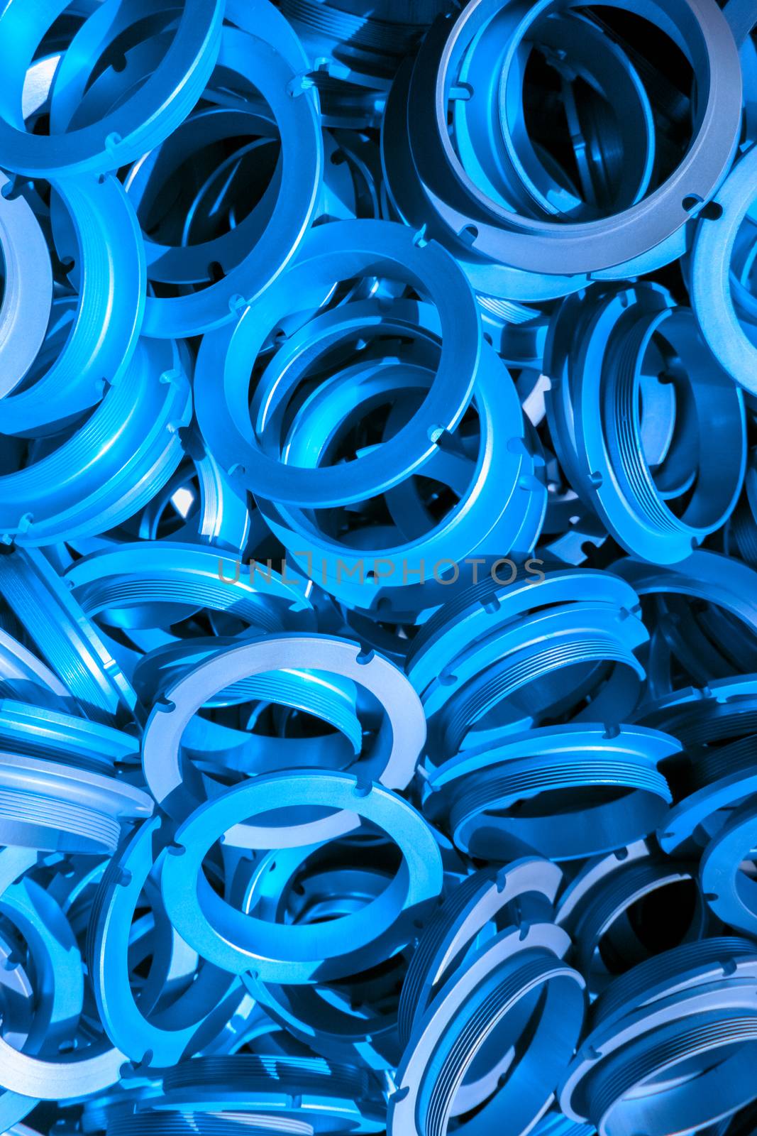 an abstract background of classic blue color coated metal ring parts.