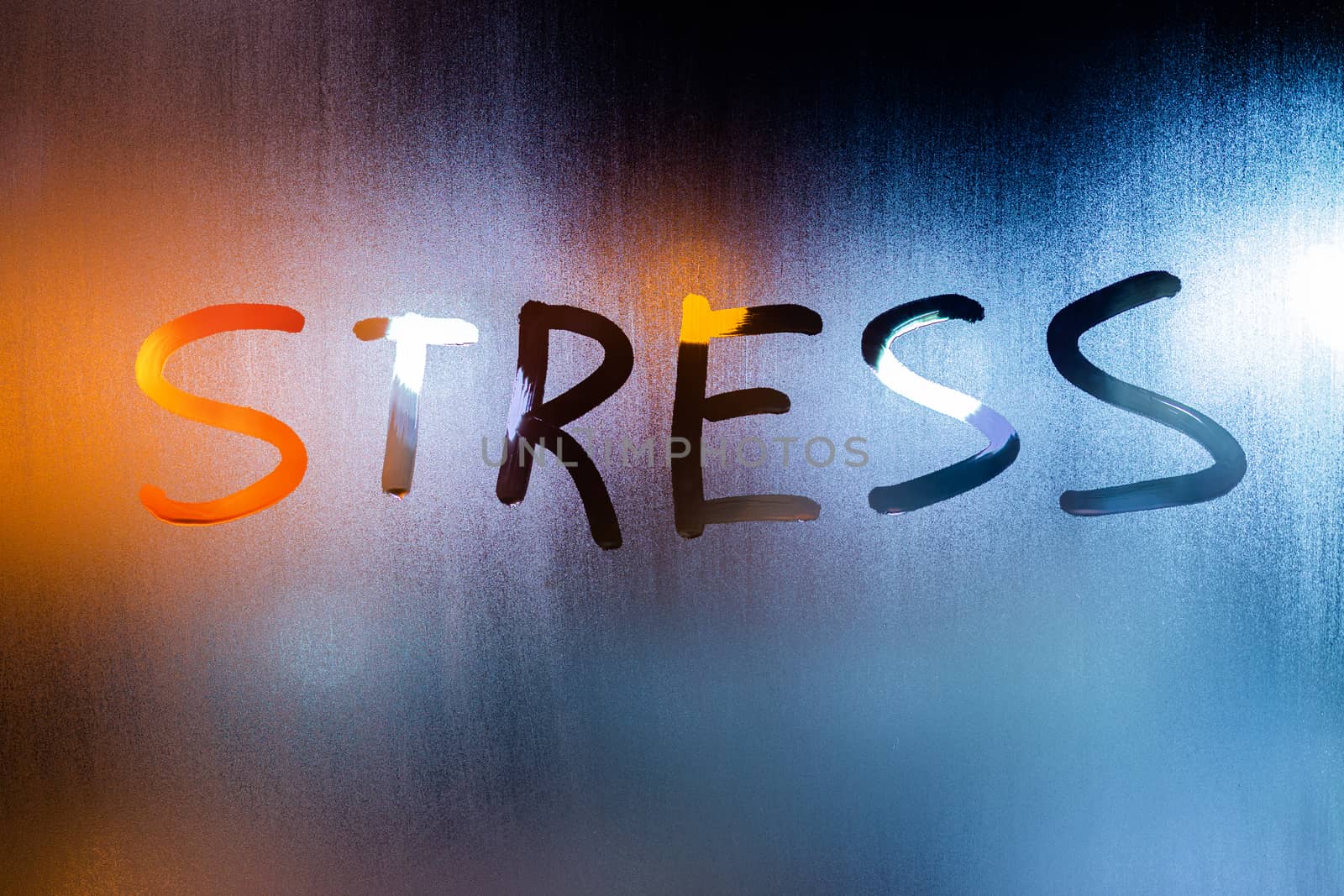the word stress handwritten on night wet window glass in teal-orange tones with selective focus.