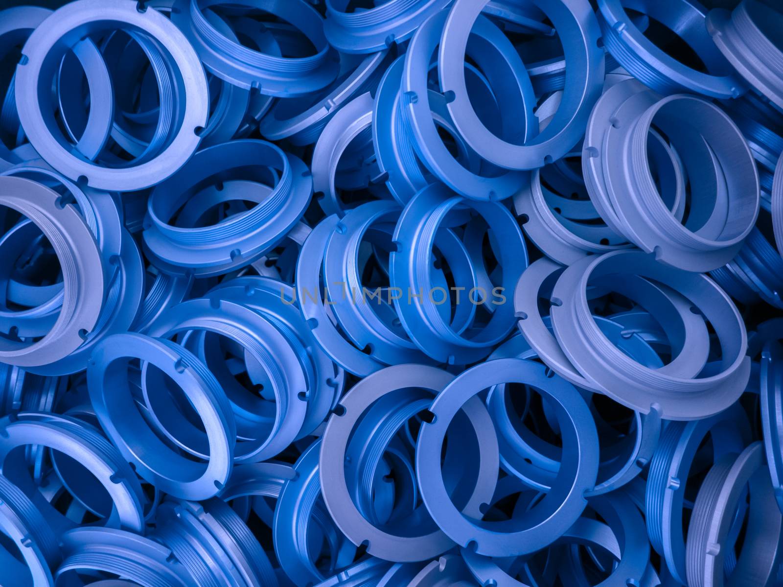 an abstract background of blue phantom blue color coated metal ring parts.