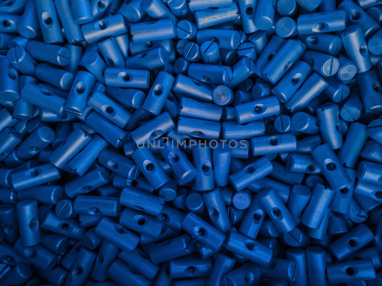 an abstract background of blue coated small metal parts.