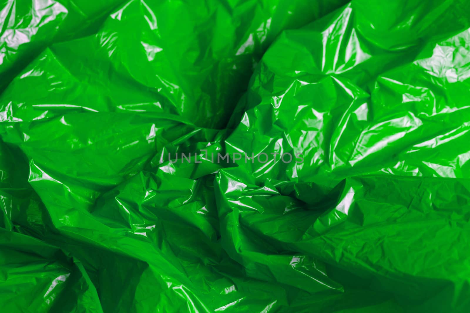 crumpled polyethilene film abstract background with selective focus.