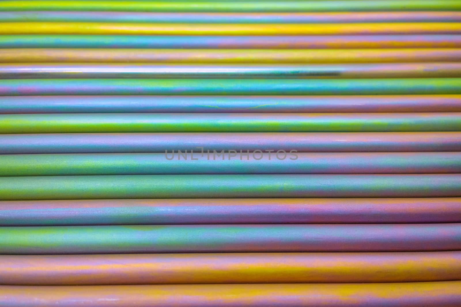 An abstract lines backround of colorful cadmium coated steel bars. Industrial grade chemical protective coating for metal parts.