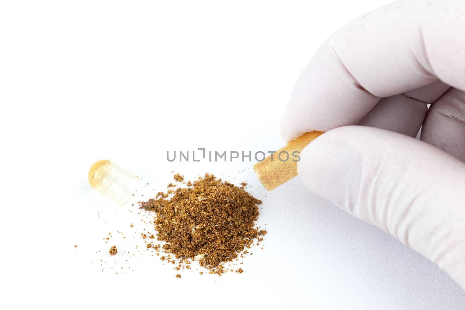 hand in medical glove opening organic med capsule isolated on white background closeup.
