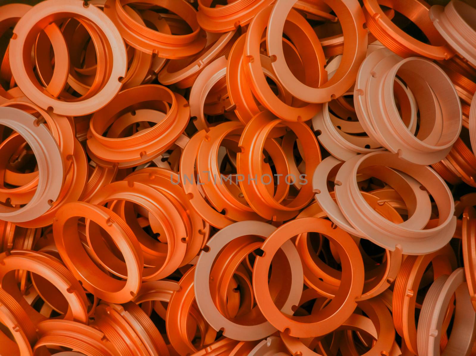 an abstract background of lush lava color coated metal ring parts.