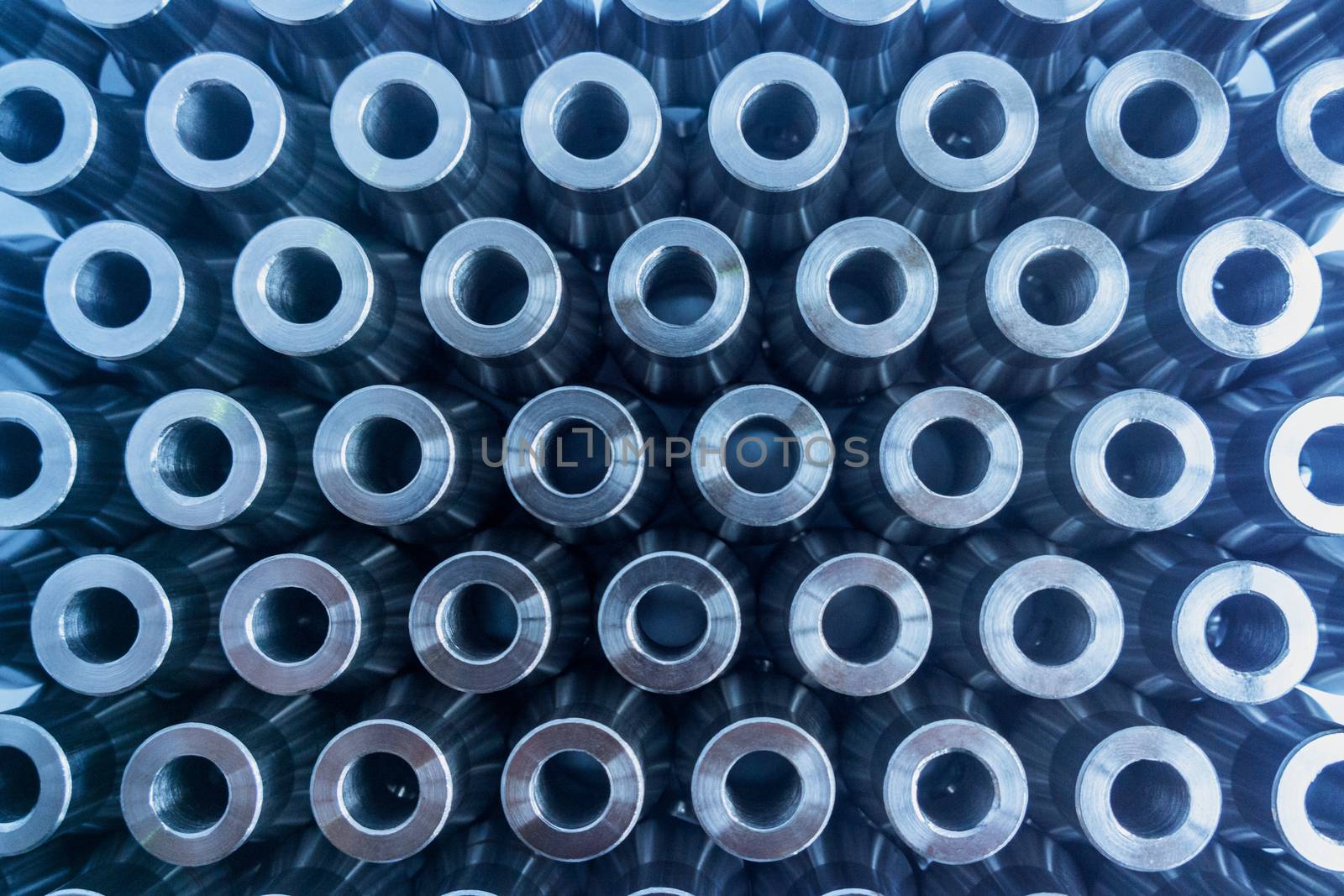 Shiny metal parts top-down view abstract background with selective focus.