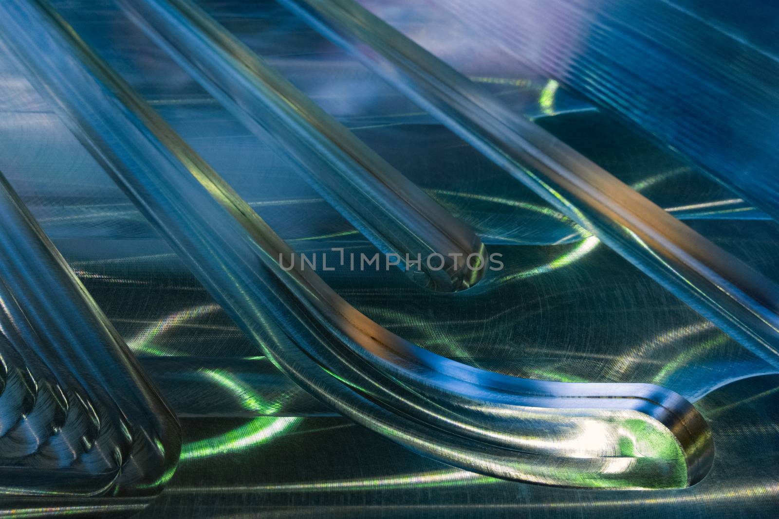 Large metal surface after end milling by large shell mill with specific concentric notches and light reflections. Selective focus closeup technique