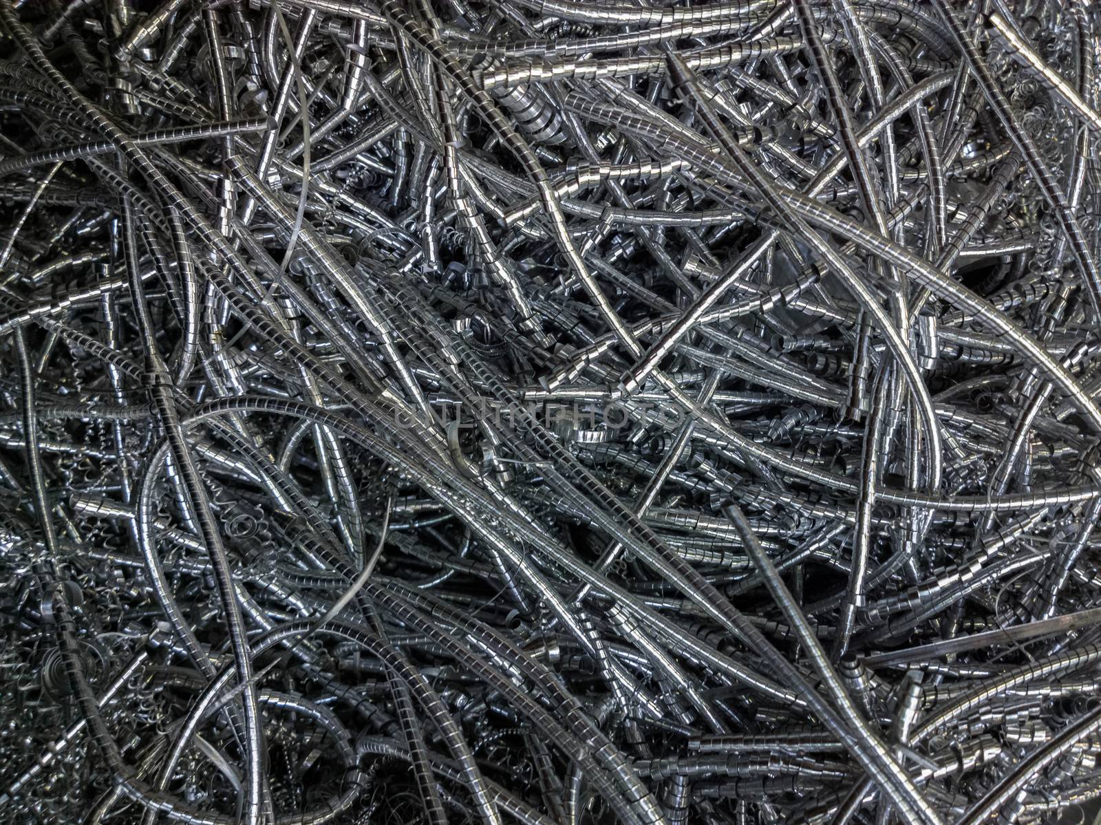 Long curly aluminium chips pattern background with selective focus.