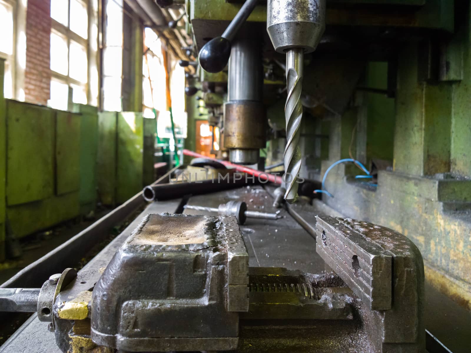 old drilling machine with obsolete used vice with selective focus.