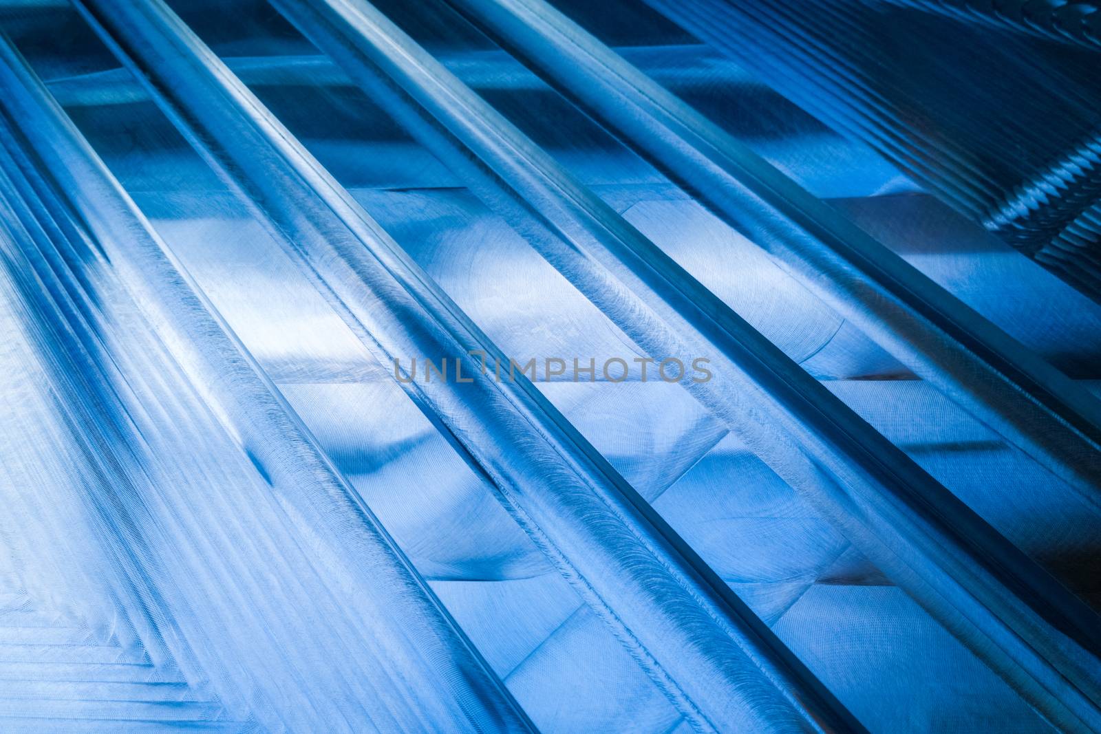 Large metal surface after end milling with specific concentric notches and light reflections. Selective focus closeup technique with optical blur