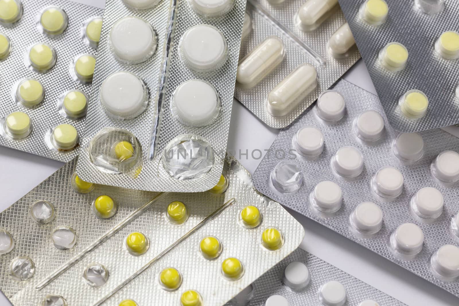 opened and partially used tablets blister background.