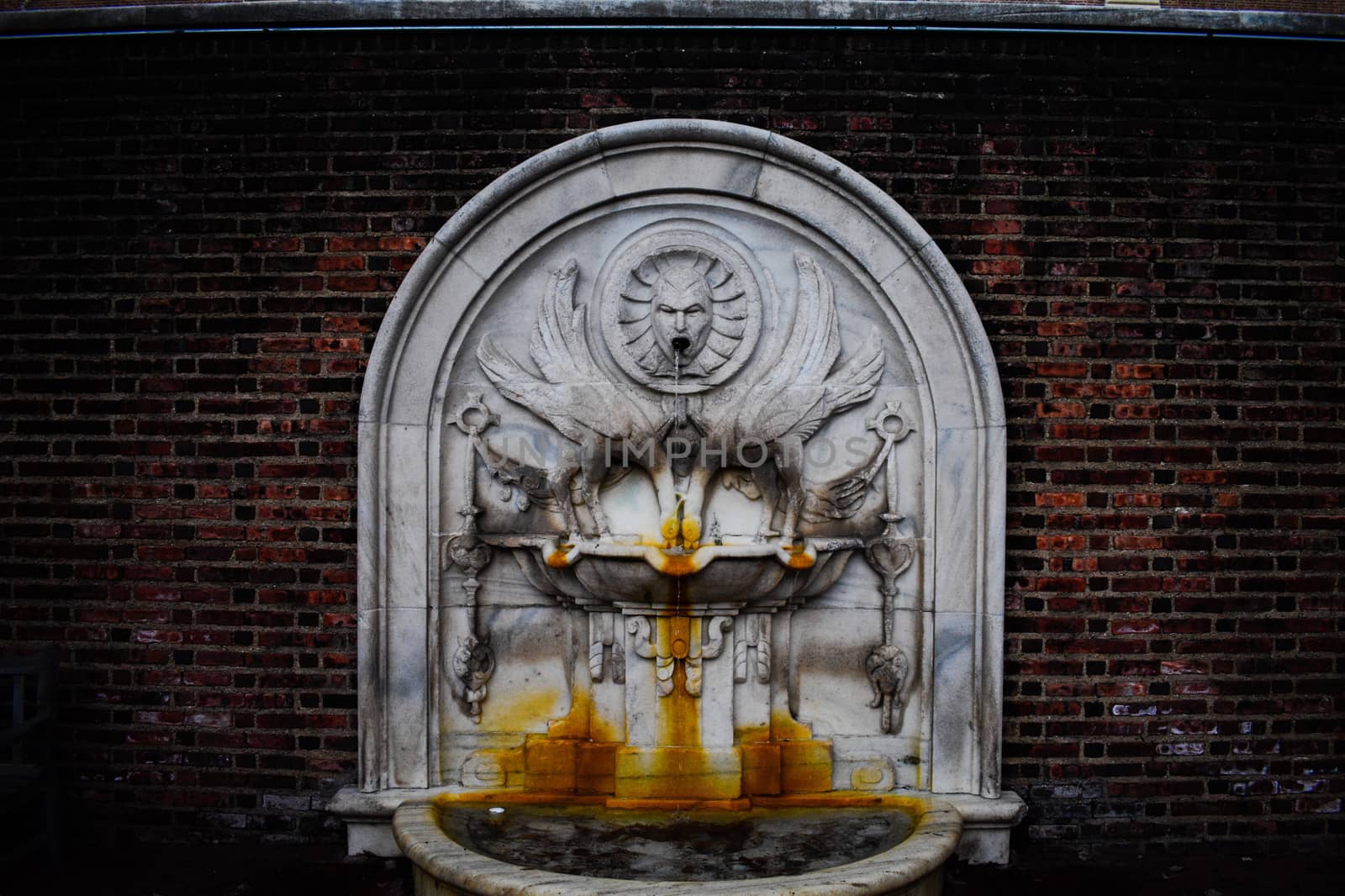 An Ornate Fountain With Rust Stains From Years of Use by bju12290