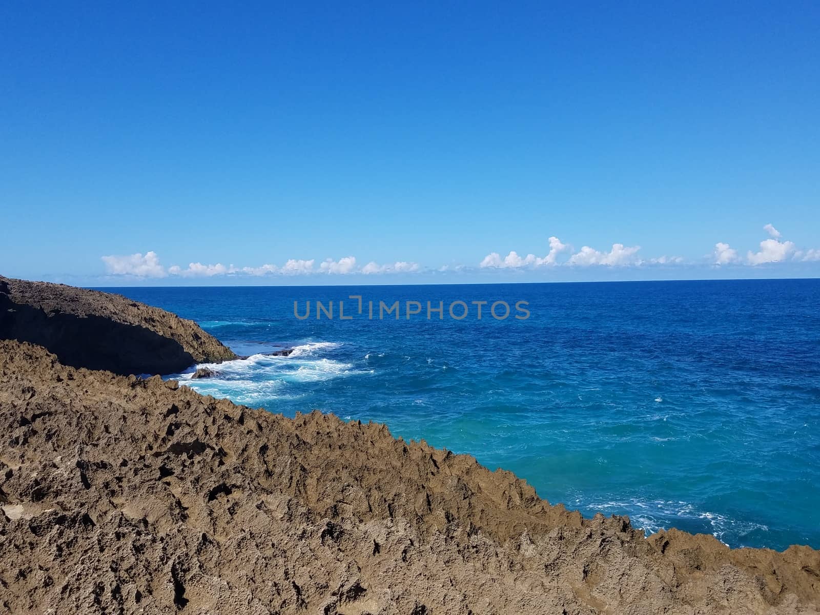 rocky shore with ocean water at beach in Isabela, Puerto Rico