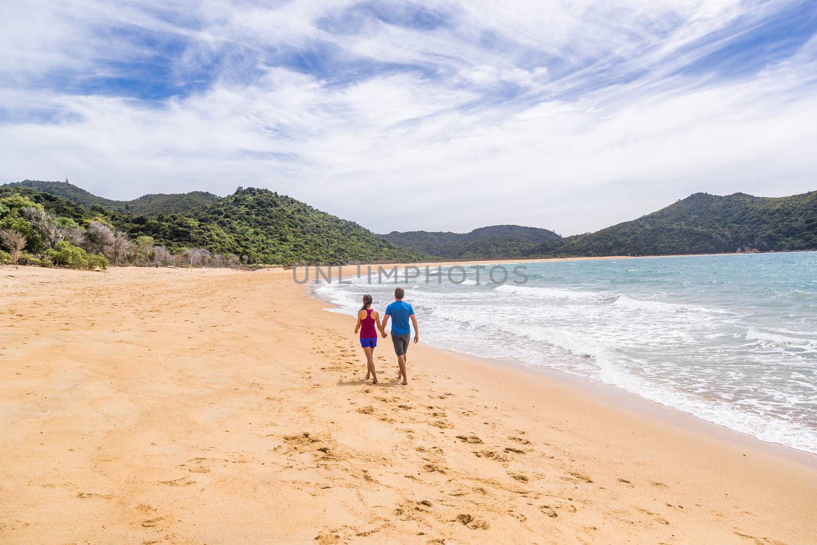 Abel Tasman National Park beach tourists hikers tramping on coast track trail, famous travel destinatinon. Wilderness reserve at the north end of New Zealand's South Island. by Maridav