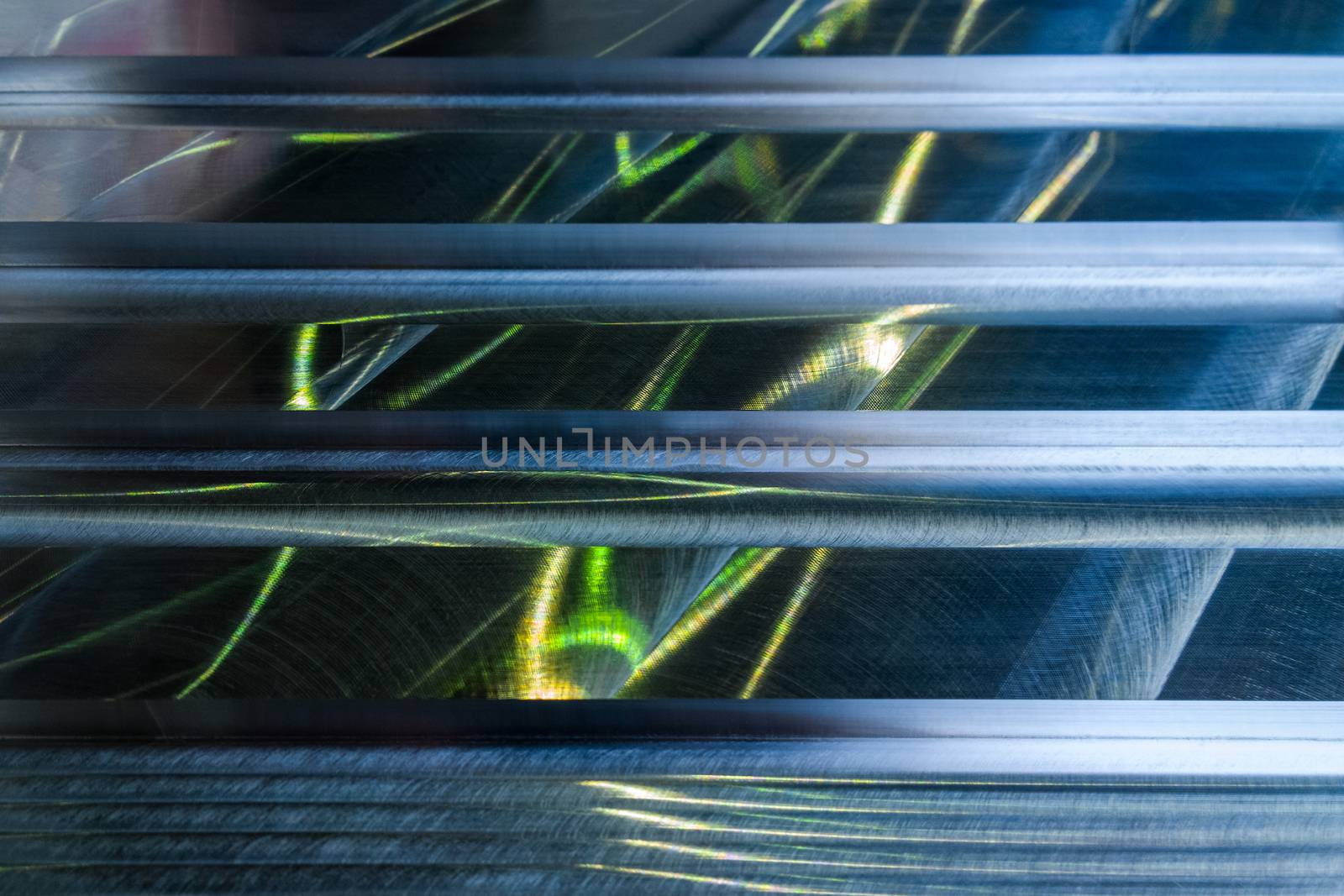 Large metal surface after end milling by large shell mill with specific concentric notches and light reflections. Selective focus closeup technique