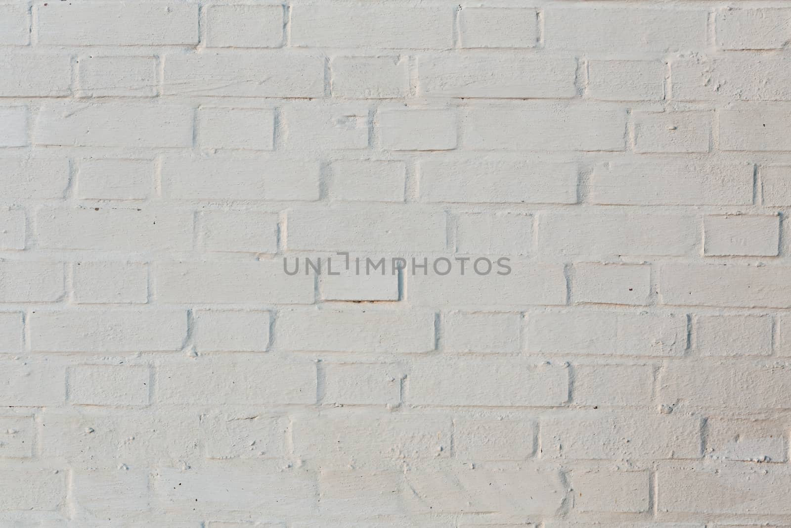whitewash brick wall horizontal background with side sunlight