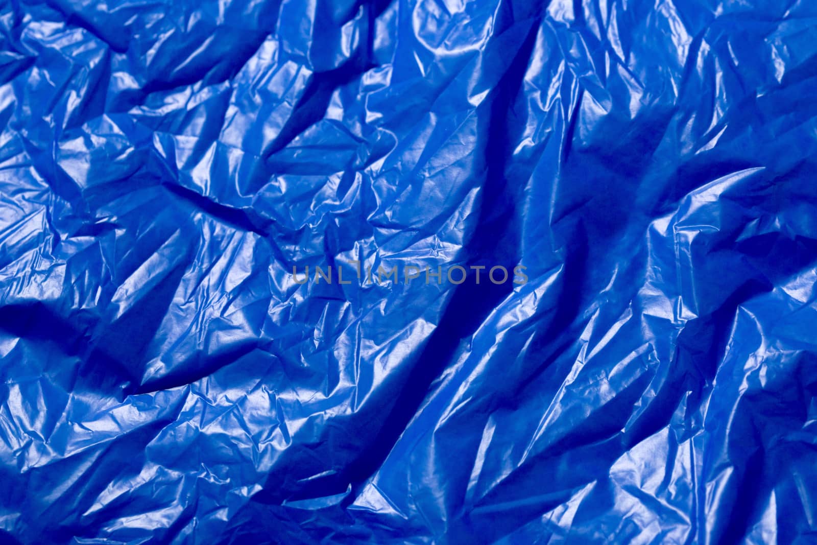 crumpled polyethilene film abstract background with selective focus.