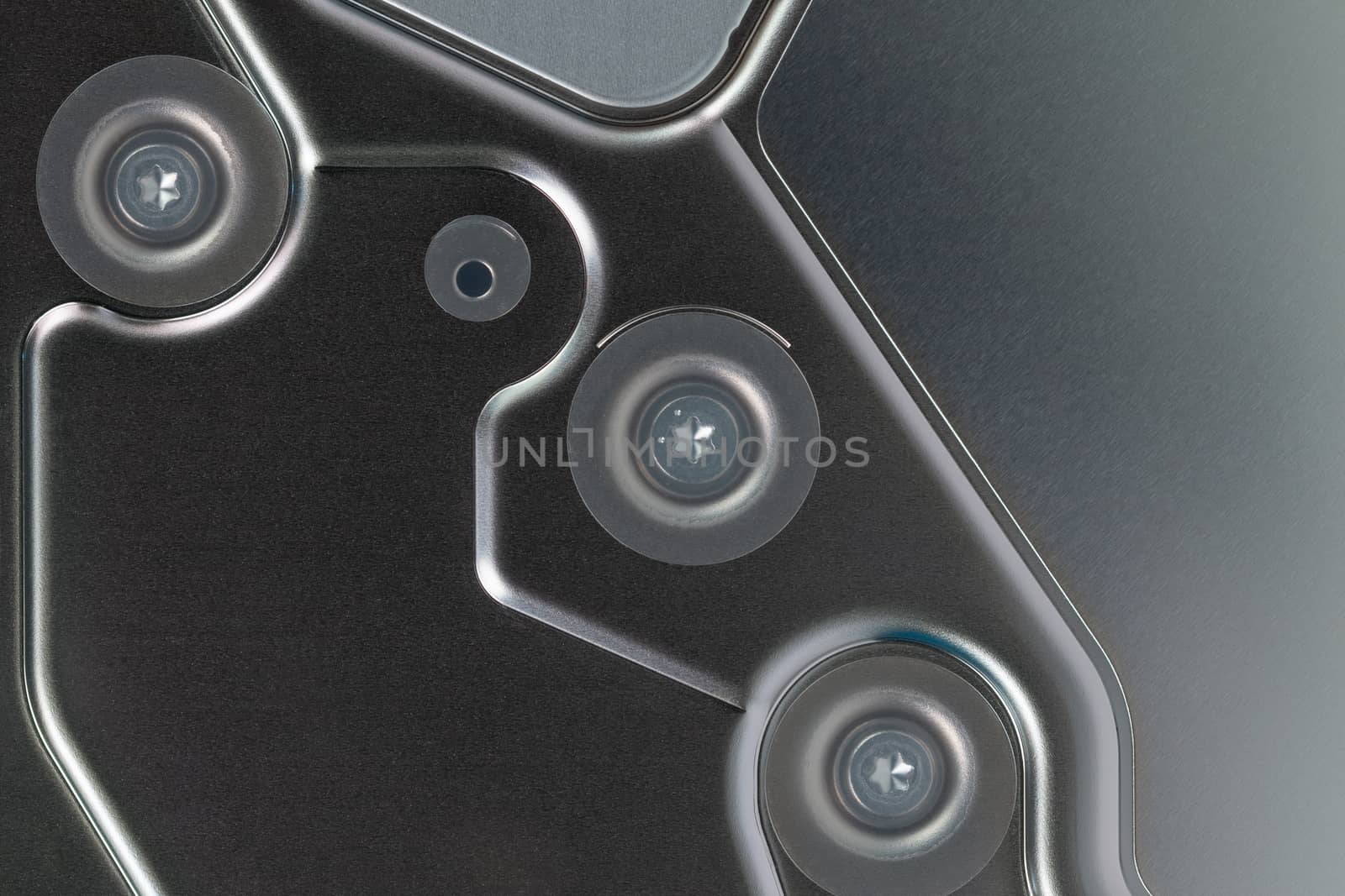 abstract metal tech background of shiny steel panel of computer hard disk drive unit.